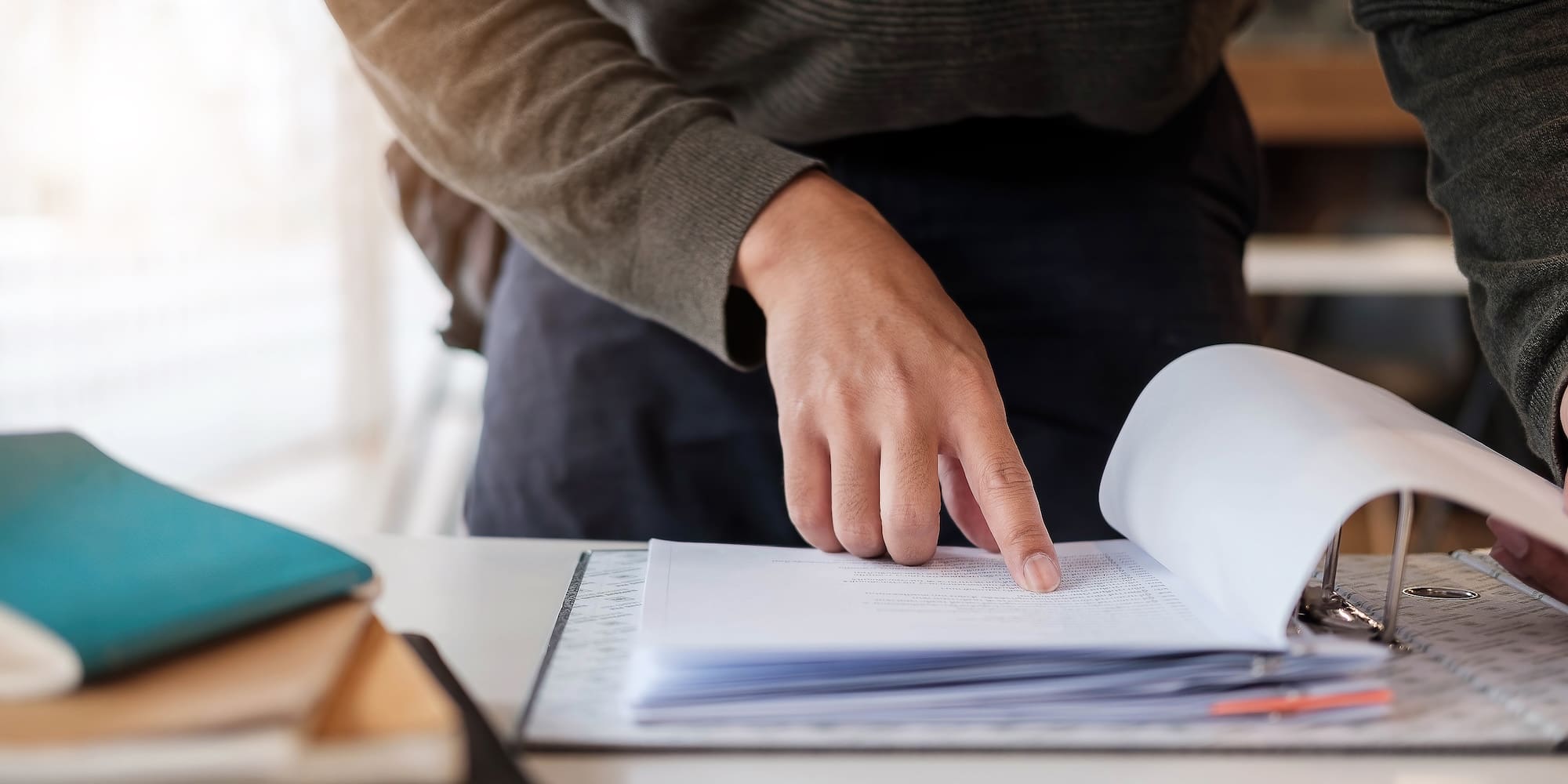 reviewing financial and tax documents with a calculator 