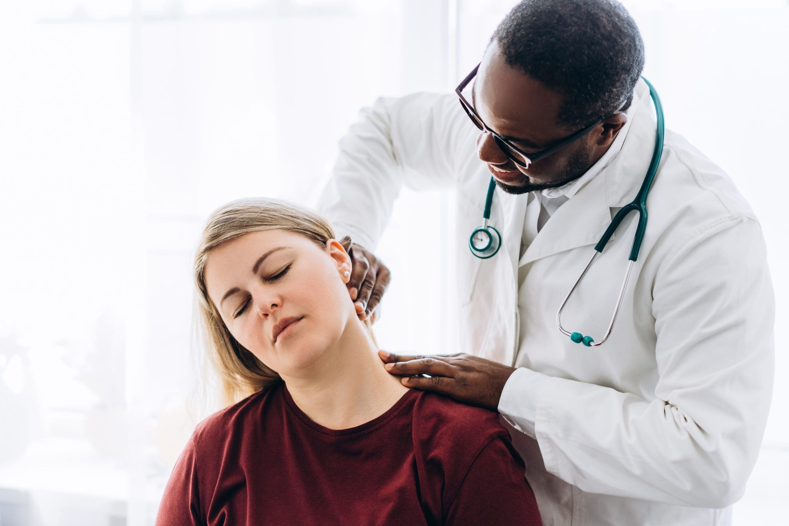 Caring doctor examines a woman in medical setting
